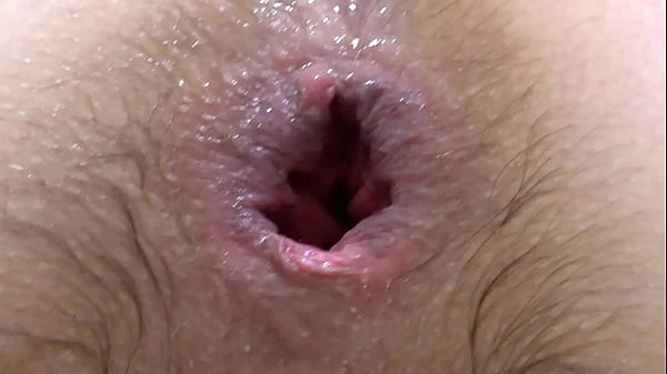 Gaping asshole. A brunette with a hairy pussy fucks her booty, stretches her anus and experiences an anal orgasm.